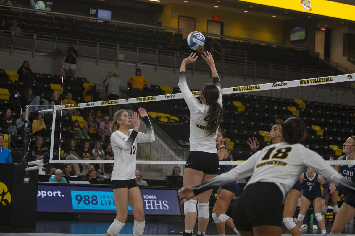 Iowa setter, Claire Ammeraal (4), sets the ball to outside hitter, Hannah Whittingstall (12), during a game between Iowa and Cal Baptist at Xtream Arena in Coralville on Saturday, Sept. 7, 2024. The Hawkeyes defeated the Lancers 3-0.