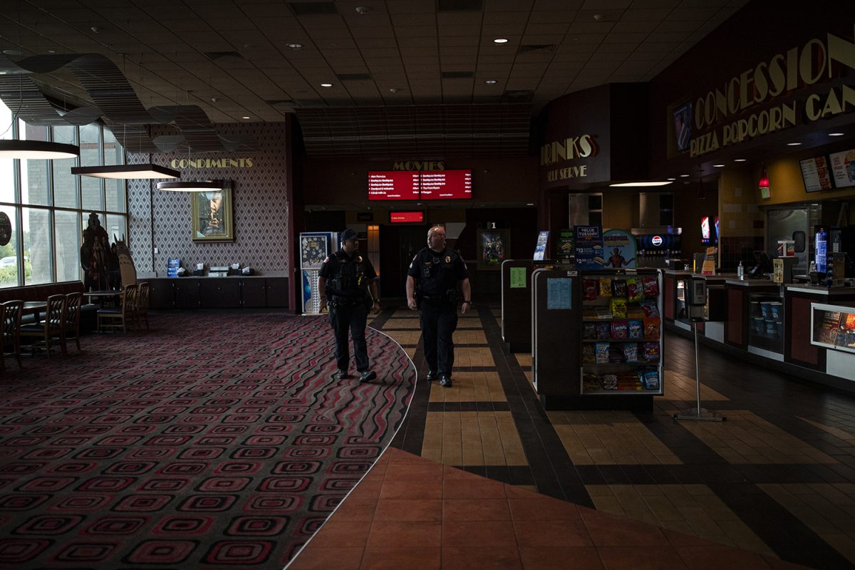 Police officers walk through Marcus Theaters before a Young Americans for Freedom group screening of Matt Walsh’s “Am I Racist” at the Coral Ridge Mall on Monday, Sept. 9, 2024. Walsh came to the University of Iowa’s campus in April of 2023 for a screening of “What is a Woman?” at the Iowa Memorial Union.