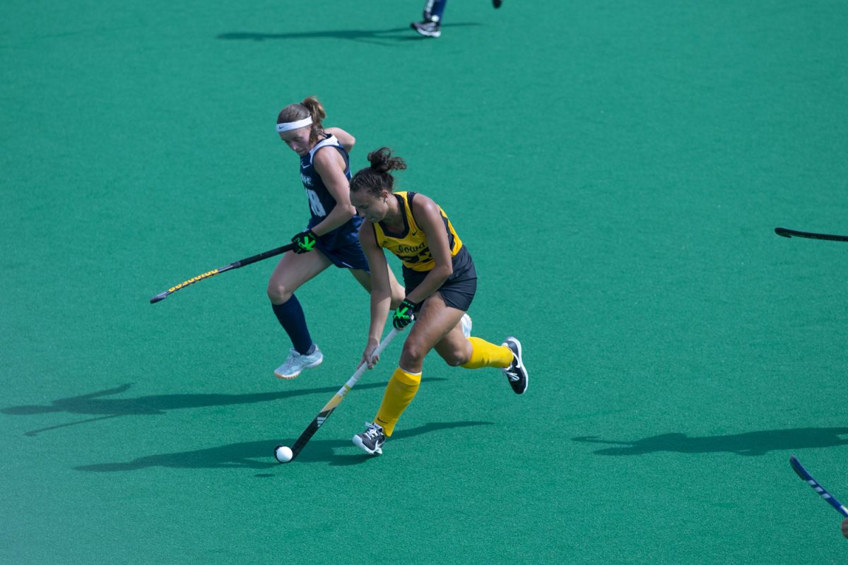 Iowa defense Harper Dunne (23) keeps the ball away from a Wildcat during a field hockey game between Iowa and New Hampshire at Grant Field in Iowa City, Iowa on Friday Sept. 13, 2024. The Hawkeyes defeated the Wildcats 5-0.