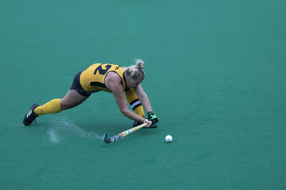 Iowa player Milly Short (12) hits the ball during a field hockey game between Iowa and New Hampshire at Grant Field in Iowa City, Iowa on Friday Sept. 13, 2024. The Hawkeyes defeated the Wildcats 5-0.