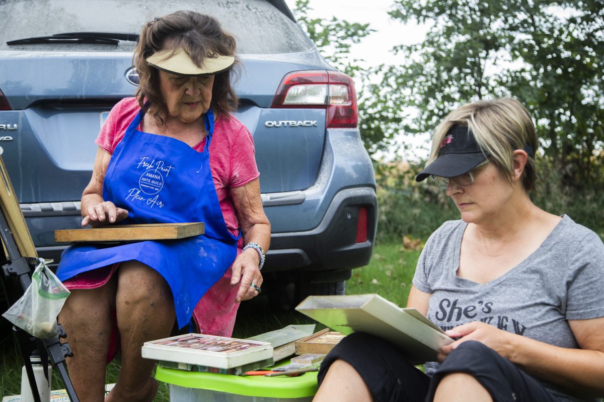 Beppie Weiss (left) and Andrea Gage (right) work with pastels during a plein air painting session organized by the ArtiFactory and hosted at the Secrest 1883 Octagonal Barn in West Liberty on Sept. 14. “Plein air” refers to the art form of painting outside and capturing the natural spirit of a subject or landscape in the artist’s full view.