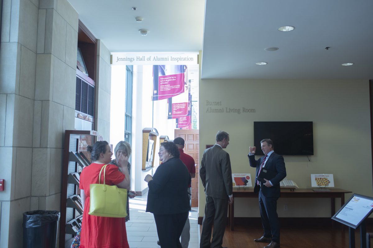 Attendees and board members converse outside of the Reiman Ballroom during a board meeting at the Iowa State Alumni Building in Ames on Wednesday, Sept. 18, 2024.