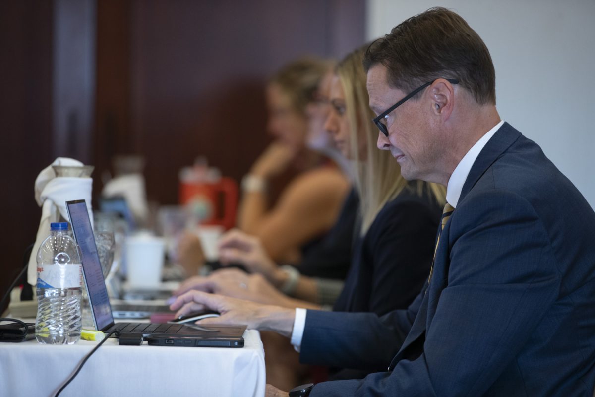 A Board of Regents staff member reacts to a presentation during a board meeting at the Iowa State Alumni Building in Ames on Wednesday, Sept. 18, 2024.