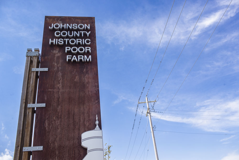 The Johnson County Historic Poor Farm sign is seen at the entryway of the farm in Iowa City on Thursday, Sept. 19, 2024. The poor farm will undergo construction in the coming weeks. 