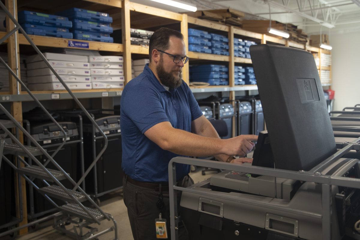 Poll worker Nathan Mueller interacts with voting equipment at the Johnson County Administration Building in Iowa City on Sept. 20.
Testing of the ballot machines will take place on Sept. 30 starting at 10 a.m. and continue until completion. Testing is open to the public and
attendance is encouraged. Around 5,000 ballots will run through the machines in testing alone.