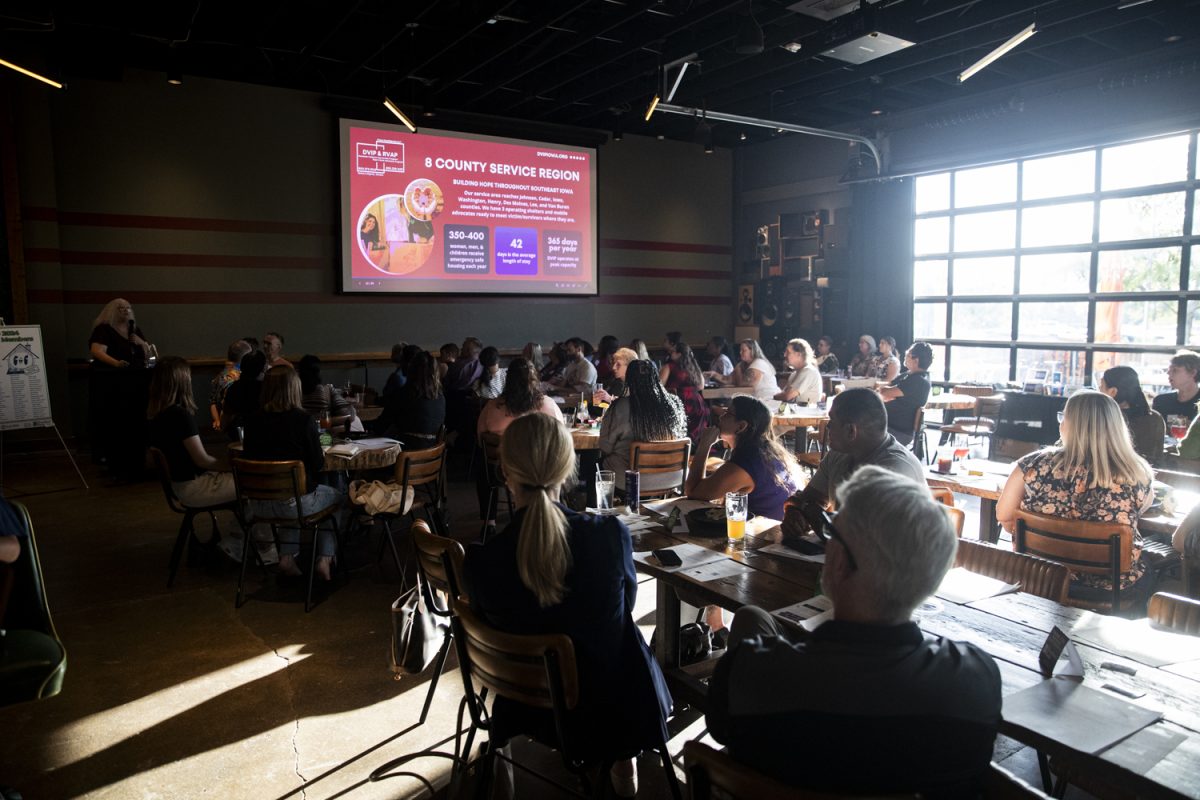 Attendees listen to the Executive Director of the Domestic Violence and Intervention Program, Kristie Fortmann Doser, during an annual Johnson County Affordable Housing Coalition meeting at Big Grove Brewery on Thursday, Sept. 26, 2024. The Affordable Housing Coalition’s mission is to increase access to affordable housing for lower-income people living in Johnson County through education, advocacy, and partnership.