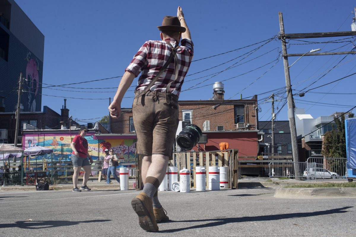 Matt Dannenberg is seen keg bowling during the Northside Oktoberfest at the Iowa City Downtown District on Saturday, Sept. 28, 2024. The festival included beer samples, activities, live music, and even a kids section called ‘SodaFest’. Dannenberg mention that this is his second year attending the Northside Oktoberfest.