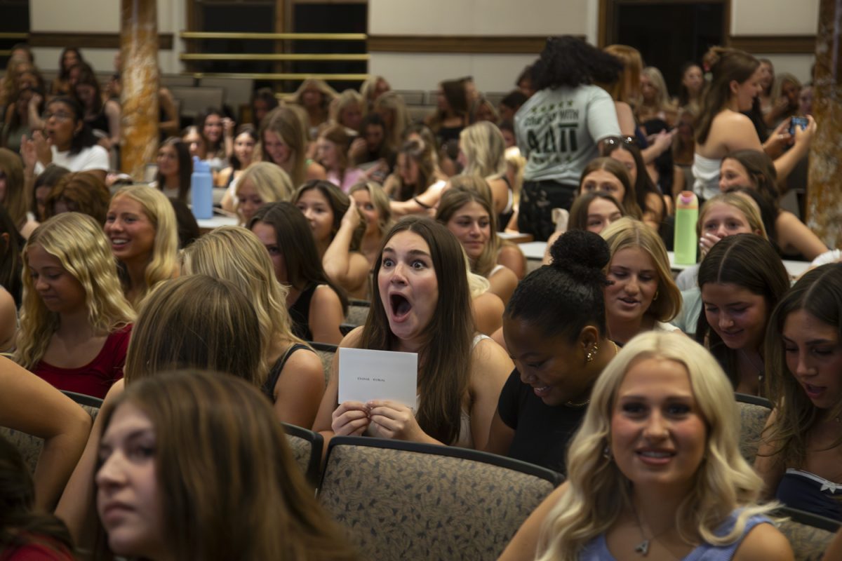 Emma Robin,a potiental new member, prepares to open her bid decision during Iowa's Bid Day in Iowa City on Sunday, Sept. 29, 2024. There were almost 600 new members at this year’s ceremony, which took place in Macbride Hall before moving out to the Pentacrest for a celebration.