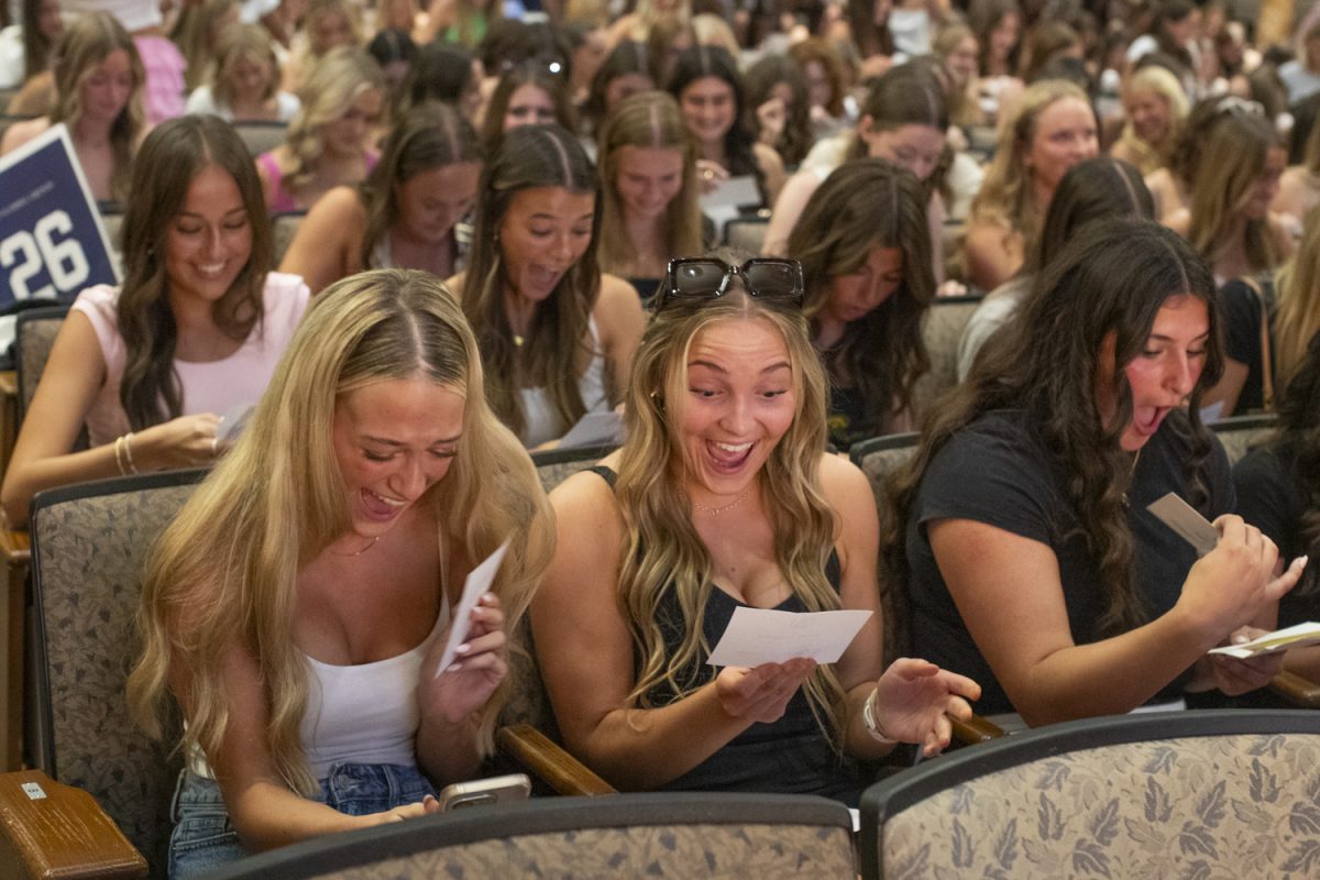 A potential new member opens her letter and finds out her sorority during Bid Day for sororities in Iowa City on Sunday, Sept. 29, 2024. There were almost 600 new members at this year’s ceremony, which took place in Macbride Hall before moving out to the Pentacrest for a celebration.