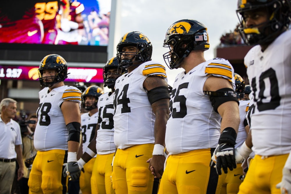 Iowa players walk onto the field before a football game between Iowa and Minnesota at Huntington Bank Stadium in Minneapolis, MN on Saturday, Sept. 21, 2024. The Hawkeyes defeated the Golden Gophers 31-14, taking back the Floyd of Rosedale Trophy.