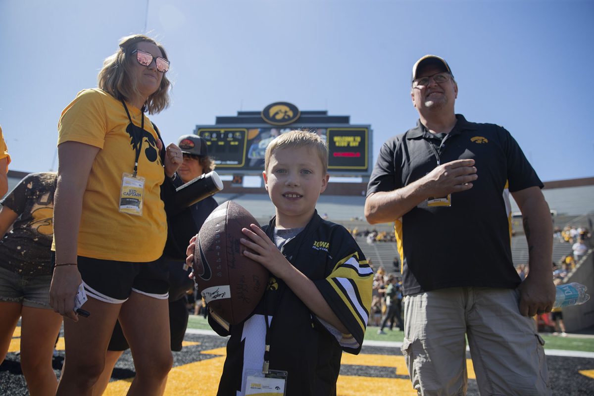 Iowa kid captain Aiden Washbern poses for a portrait with family members during Kid's Day at Kinnick in Iowa City on Aug. 10, 2024. 