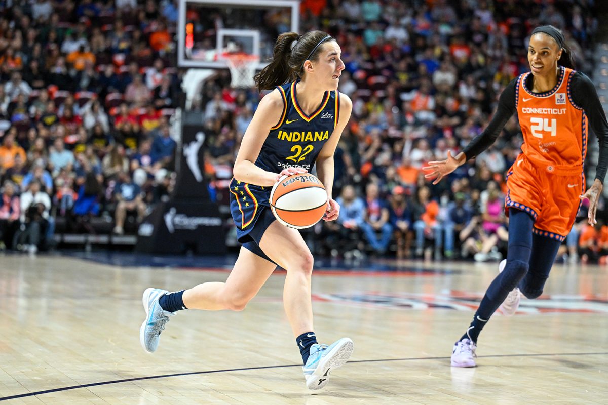 Sep 22, 2024; Uncasville, Connecticut, USA; Indiana Fever guard Caitlin Clark (22) dribbles the ball chased by Connecticut Sun forward DeWanna Bonner (24) in the first quarterduring game one of the first round of the 2024 WNBA Playoffs at Mohegan Sun Arena. 