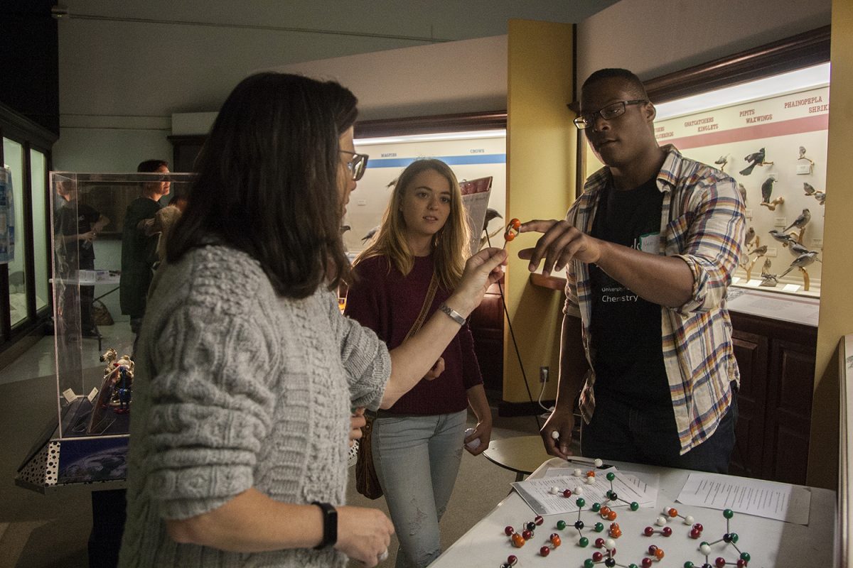 An attendee asks about a molecular formation during the Iowa Climate Festival at the Museum of Natural History in Iowa City on Saturday, Oct 15, 2016. There were hands-on experiments at the Climate Science Fair for attendees to interact and learn with. 