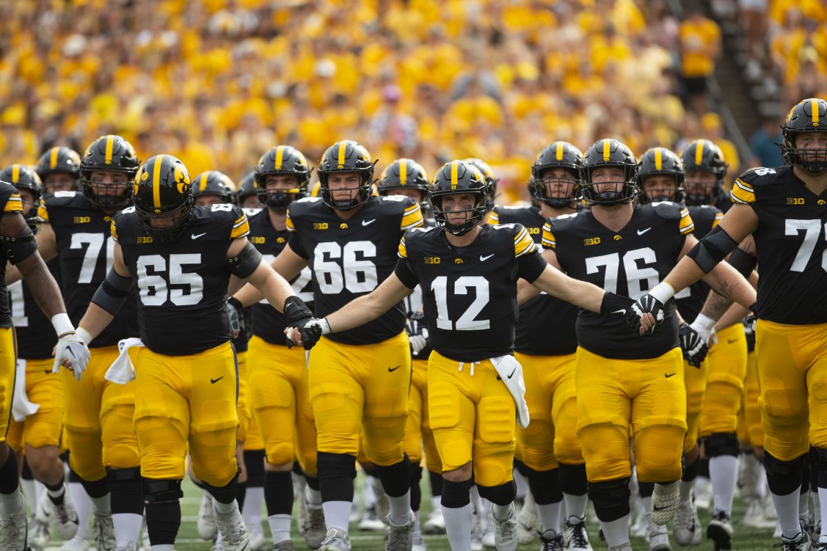 Iowa football players swarm during a football game between Iowa and Troy at Kinnick Stadium on Saturday, Sept. 14, 2024. The Hawkeyes defeated the Trojans, 38-21. 
