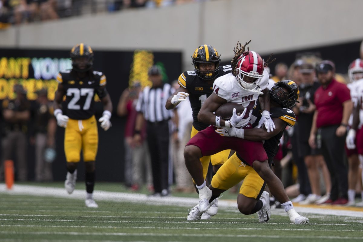 Troy tight end Ethan Conner is tackled by Iowa players during a football game between Iowa and Troy at Kinnick Stadium on Saturday, Sept. 14, 2024. The Hawkeyes defeated the Trojans, 38-21. Conner received for 50 yards. 