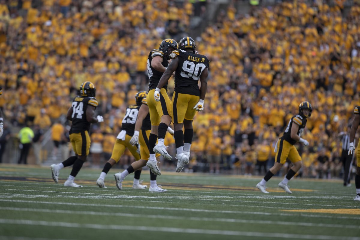 Iowa defensive end Brian Allen Jr. and Alec Wick celebrate as Troy does not score in their fourth down during a football game between Iowa and Troy at Kinnick Stadium on Saturday, Sept. 14, 2024. The Hawkeyes defeated the Trojans, 38-21. 