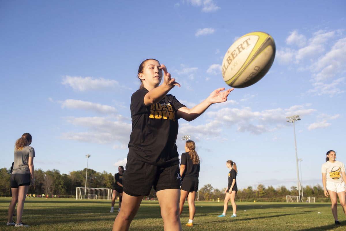 An Iowa women’s rugby player warms up with teammates before a practice at the Hawkeye Recreation Fields on Sept. 26, 2024. Despite a lack of athletics funding, the team self-funds to
travel around the Midwest for matches.