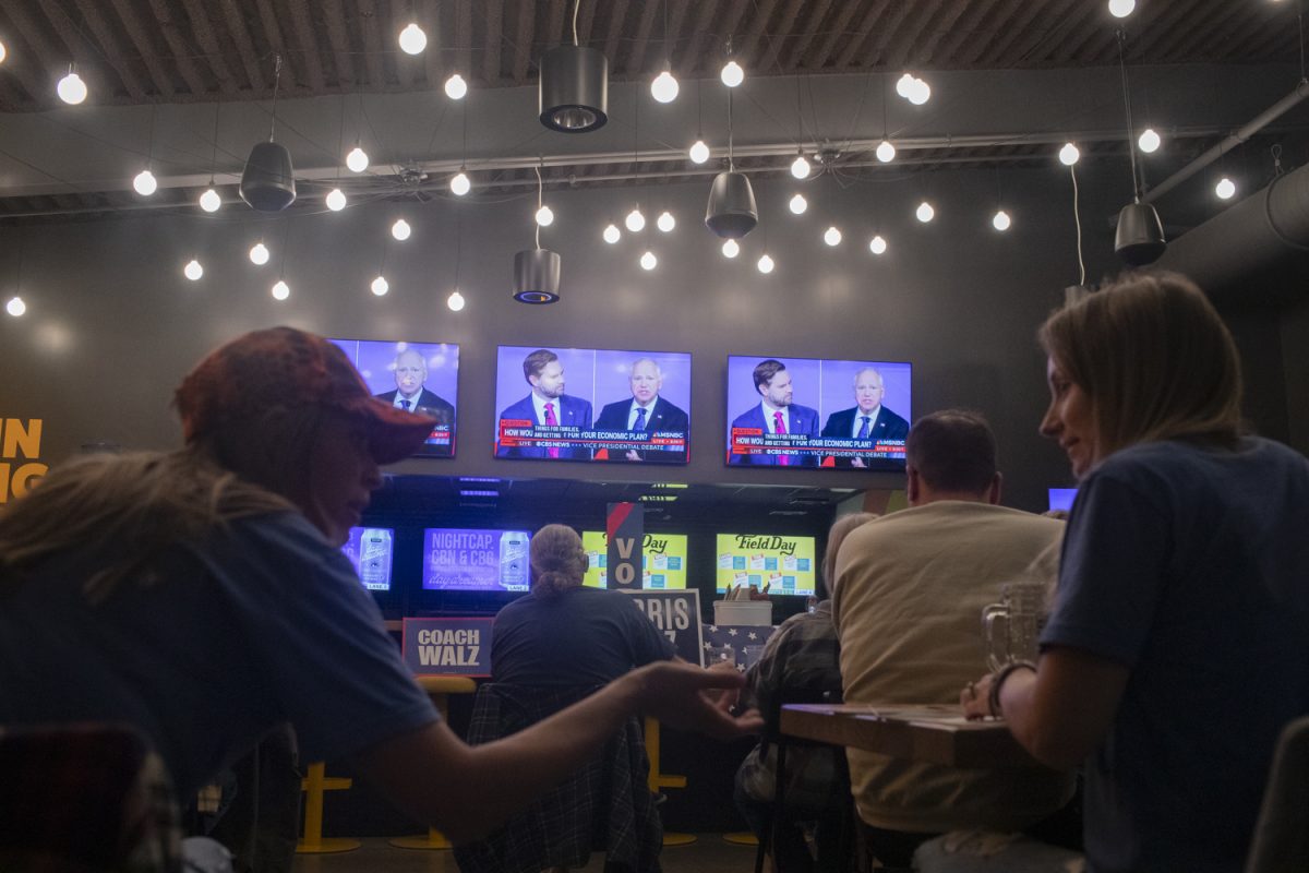 Guests speak during a Johnson County Democrats Vice Presidential Watch Party at Field Day Brewery in North Liberty, Iowa on Tuesday, Oct. 1, 2024. State and county elected democrat officials gathered to watch and converse.