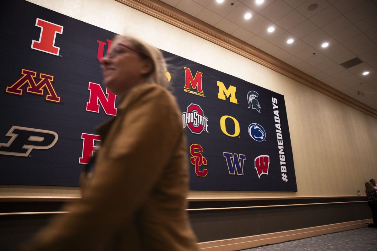 An attendee passes by a Big Ten banner outside of the main conference hall during the Big Ten Women’s Basketball Media Days at the Donald E. Stephens Convention Center in Rosemont, Illinois on Wednesday, Oct. 2, 2024. The day began with six panel discussions led by Big Ten Network moderators, which each featured three coaches.