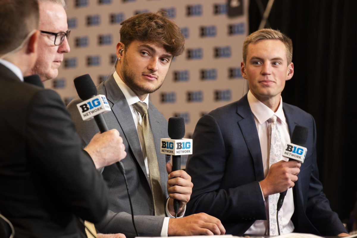 Iowa forwards Owen Freeman (second from right), Payton Sandfort (right), and head coach Fran McCaffery are asked a question in a live broadcast interview during the Big Ten Men’s Basketball Media Days at the Donald E. Stephens Convention Center in Rosemont, Illinois on Oct. 3. Podium interviews alternated between the coaches and two players from each team, lasting throughout the afternoon.