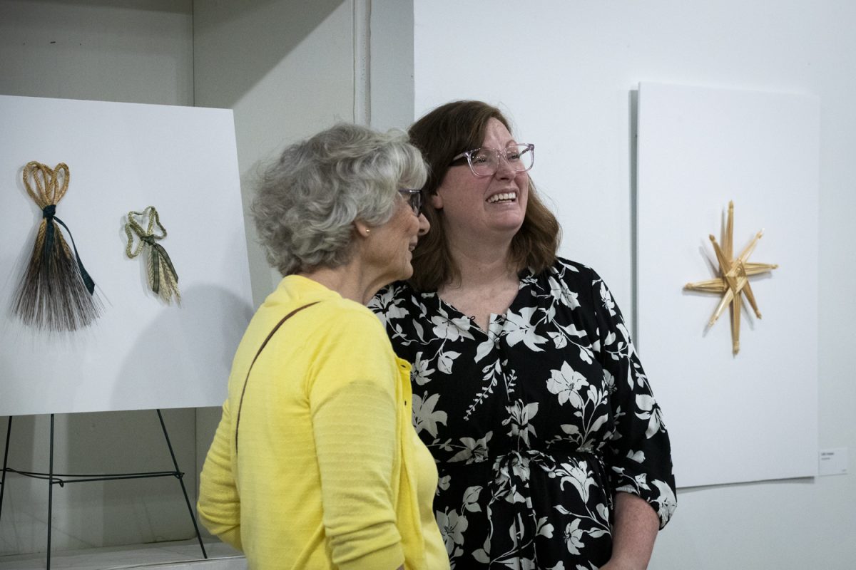 Catharine Otto discusses her work at her Gallery Walk event at The Artifactory in Iowa City on Friday, Oct. 4, 2024. Otto primarily creates fiber art projects with wheat and various other mediums.