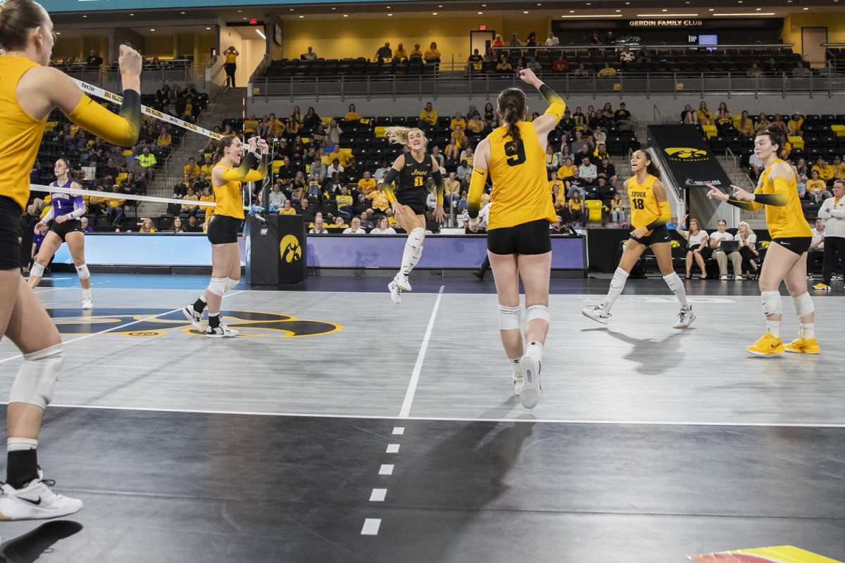 The Iowa women’s volleyball team celebrates after a kill during a volleyball game between No. 25 Washington and Iowa at Xtream Arena in Coralville on Oct. 5. The Huskies defeated the Hawkeyes, 3-0.