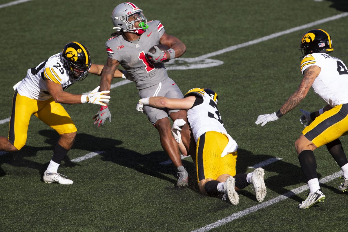 Iowa linebacker Landyn Van Kekerix and Iowa defensive back Quinn Schulte tackle Ohio State running back Quinshon Judkins during a football game between No. 3 Ohio State and Iowa at Ohio Stadium in Columbus on Saturday, Oct. 5, 2024. Judkins rushed for 71 yards averaging 7.9 yards per carry. The Buckeyes defeated the Hawkeyes 35-7.