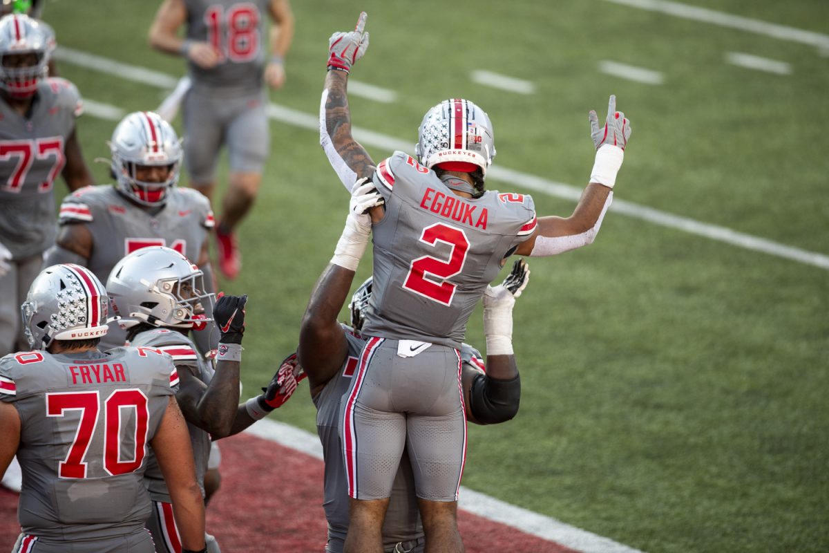 Ohio State wide receiver Emeka Egbuka embraces teammates during a football game between No. 3 Ohio State and Iowa at Ohio Stadium in Columbus on Saturday, Oct. 4, 2024. Egbuka received 71 yards, averaging 7.9 per carry, and had three touchdowns. The Buckeyes defeated the Hawkeyes 35-7.