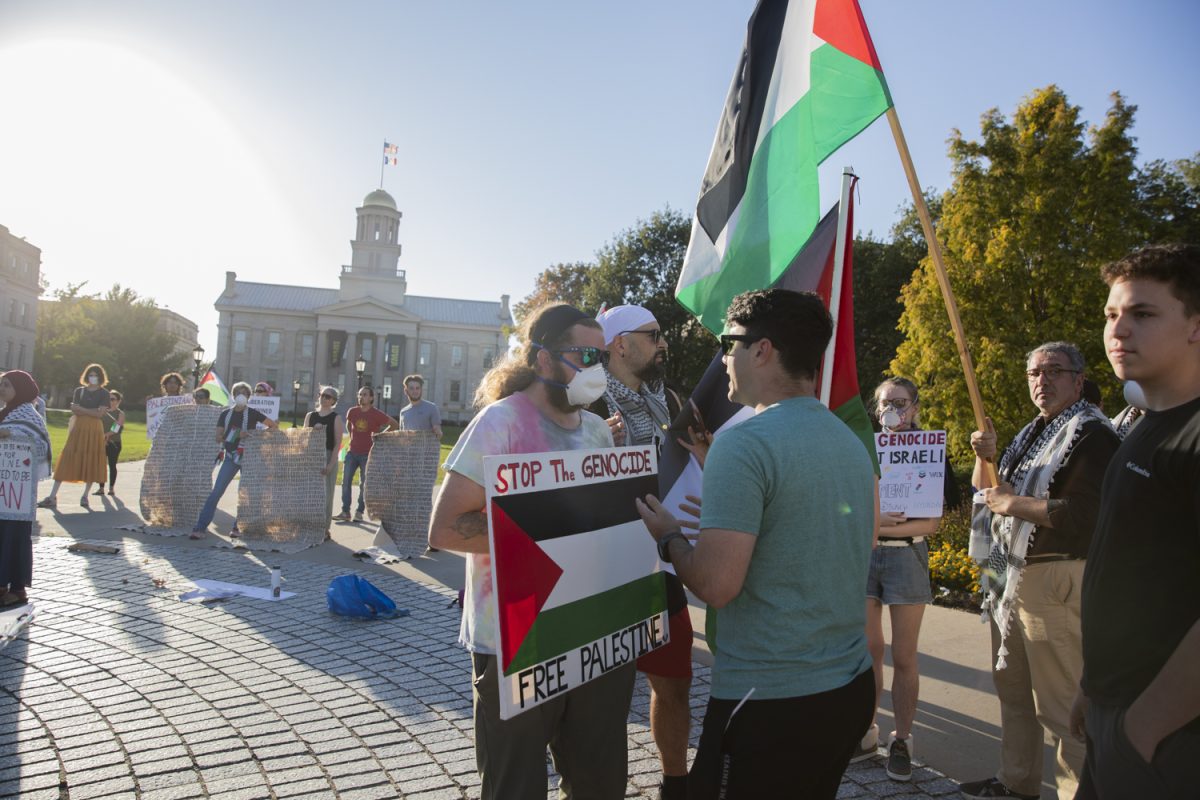 Pro-Palestine protesters interact with pro-Israel protesters during an International day of action protest by Iowans for Palestine at the Pentacrest in Iowa City on Saturday, Oct. 5, 2024. With the anniversary of Oct. 7, University entities have been working to ensure that free speech is protected around campus.