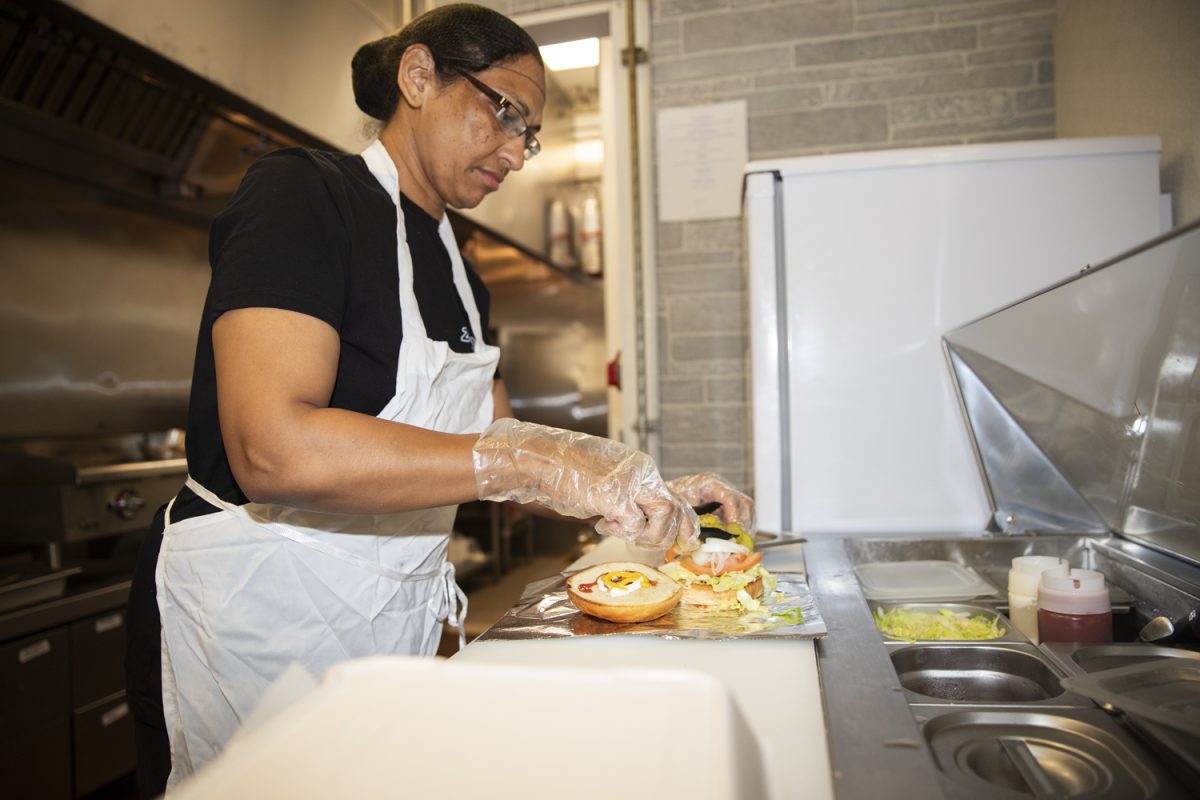 Kashmir Sood constructs a gyro cheeseburger at Zolly’s Grill in the Old Capitol Mall in Iowa City on Oct. 5. Zolly’s serves unique burgers and Halal-certified gyro.