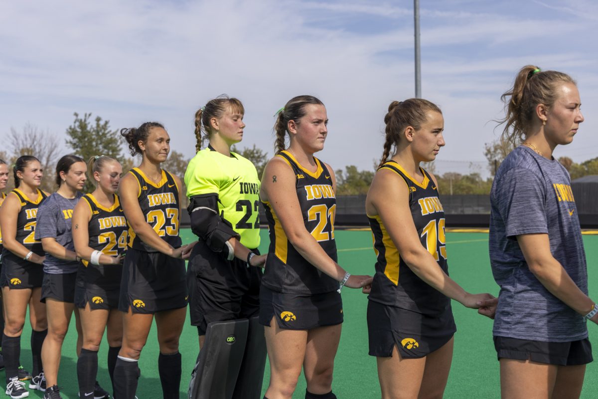 Iowa players stand for the national anthem before a field hockey game between No. 12 Iowa and Indiana at Grant Field in Iowa City on Friday, Oct. 11, 2024. The Hoosiers defeated the Hawkeyes 2-1 in double overtime.