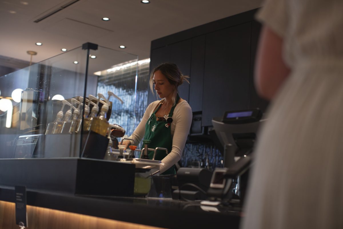 Starbucks employee Caroline Jilek makes a drink at Starbucks on Clinton Street in Iowa City on Thursday, Oct. 11, 2024. After a three-month hiatus, Starbucks reopened with updates to its layout.