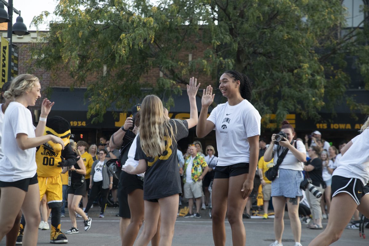 Hannah Stuelke interacts with a fan during the Hawkeyes from Downtown event at Iowa Ave and Clinton on Oct. 11, 2024 in Iowa City, Iowa. The event featured the men’s and women’s basketball teams competing in competitions with fans.