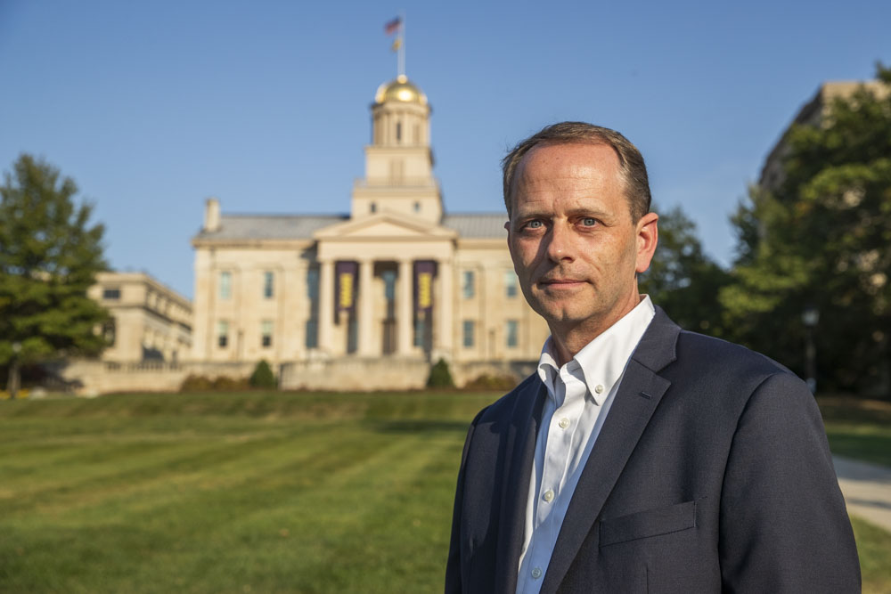 University of Iowa alumni Paul Huston poses for a portrait by the Old Capitol in Iowa City on Friday, Oct. 11, 2024. Huston now works as the Deputy Assistant Secretary of Threat Investigation and Analysis in the U.S. Department of State Diplomatic Security Service. 