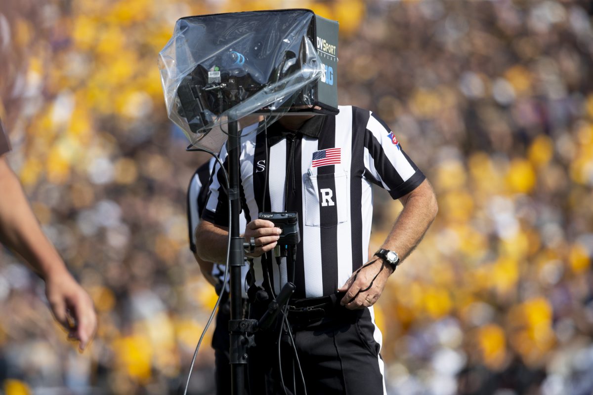 A referee watches a replay during a football game between Washington and Iowa at Kinnick Stadium in Iowa City on Saturday, Oct. 12, 2024. The Hawkeyes defeated the Huskies 40-16. (Emma Calabro/The Daily Iowan)