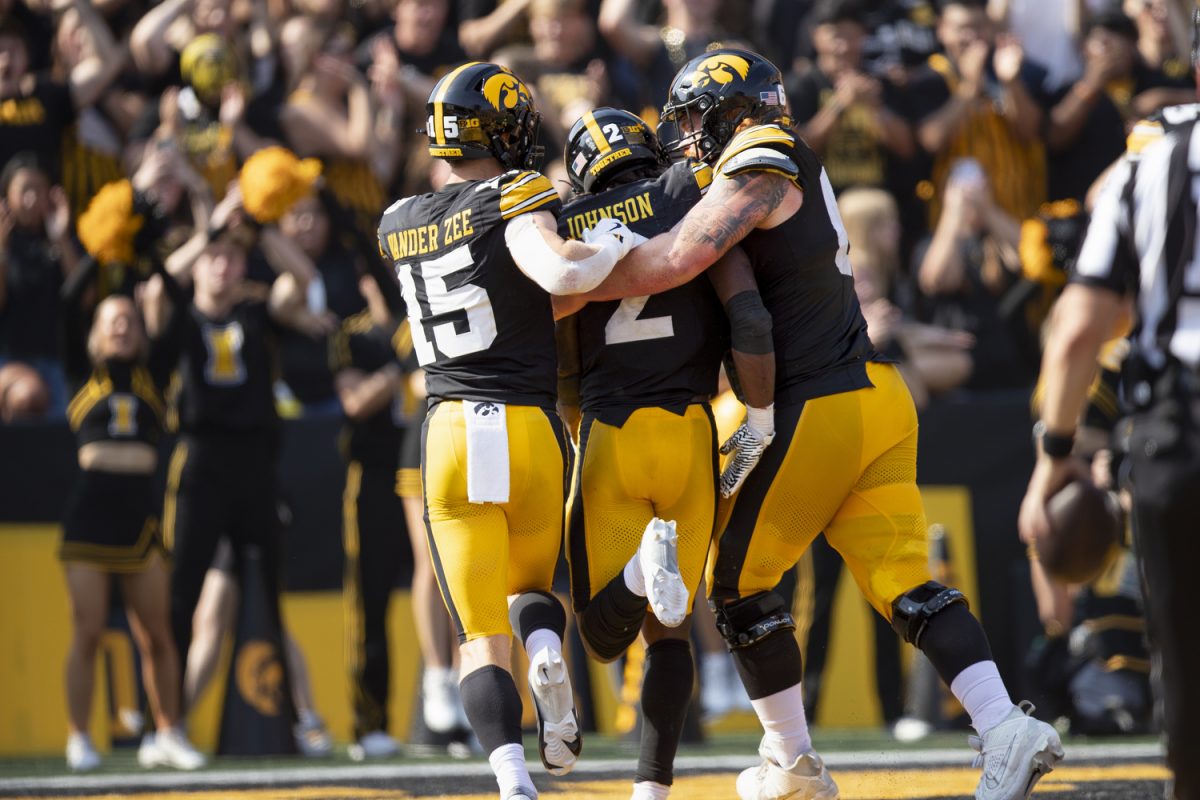 Iowa wide receiver Reece Vander Zee, Iowa running back Kaleb Johnson, and Iowa offensive lineman Gennings Dunker celebrate a touchdown during a football game between Washington and Iowa at Kinnick Stadium in Iowa City on Saturday, Oct. 12, 2024. The Hawkeyes defeated the Huskies 40-16. (Emma Calabro/The Daily Iowan)