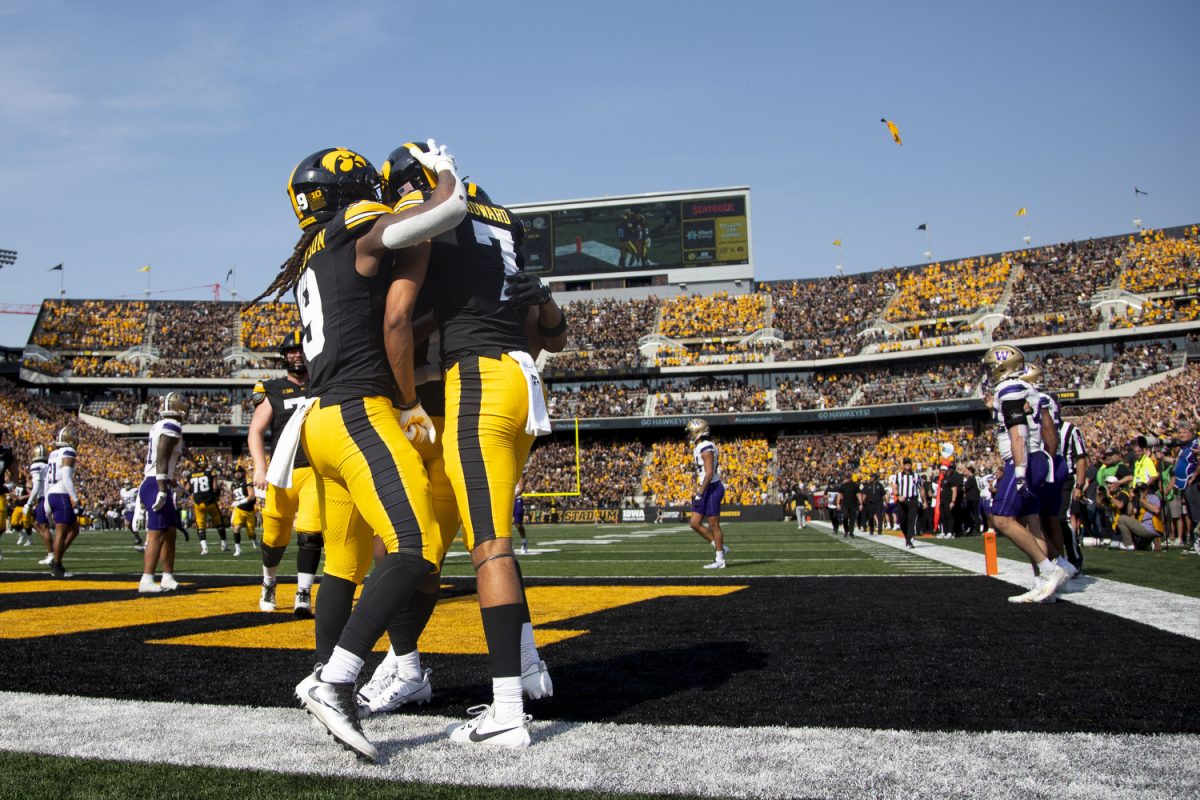 Iowa running back Jaziun Patterson and Iowa wide receiver Dayton Howard celebrate a touchdown during a football game between Washington and Iowa at Kinnick Stadium in Iowa City on Saturday, Oct. 12, 2024. The Hawkeyes defeated the Huskies, 40-16. (Emma Calabro/The Daily Iowan)