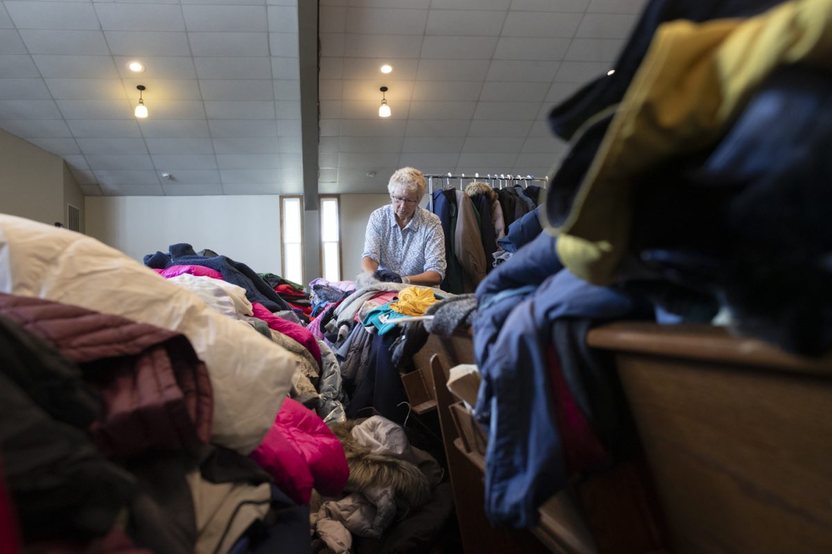 Diana Helling marks a size for a coat for a clothing drive at River Community Church in Iowa City on Oct. 14. The Consultation of Religious Communities partnered with the Iowa City Police Department to host a clothing drive with winter coats. Telling joined the Consultation of Religious Communities form her home church, St. Thomas Moore.