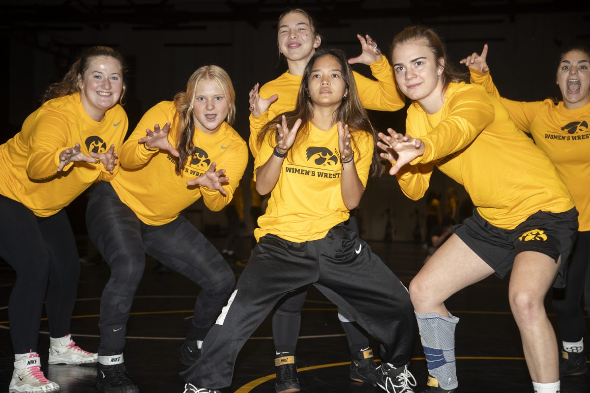 The Iowa Women’s wrestling team poses for a portrait during Iowa Women’s Wrestling media day at the Gosche Family Wrestling Facility in Iowa City on Tuesday, Oct. 15, 2024.  The team took questions and took photos with the media.