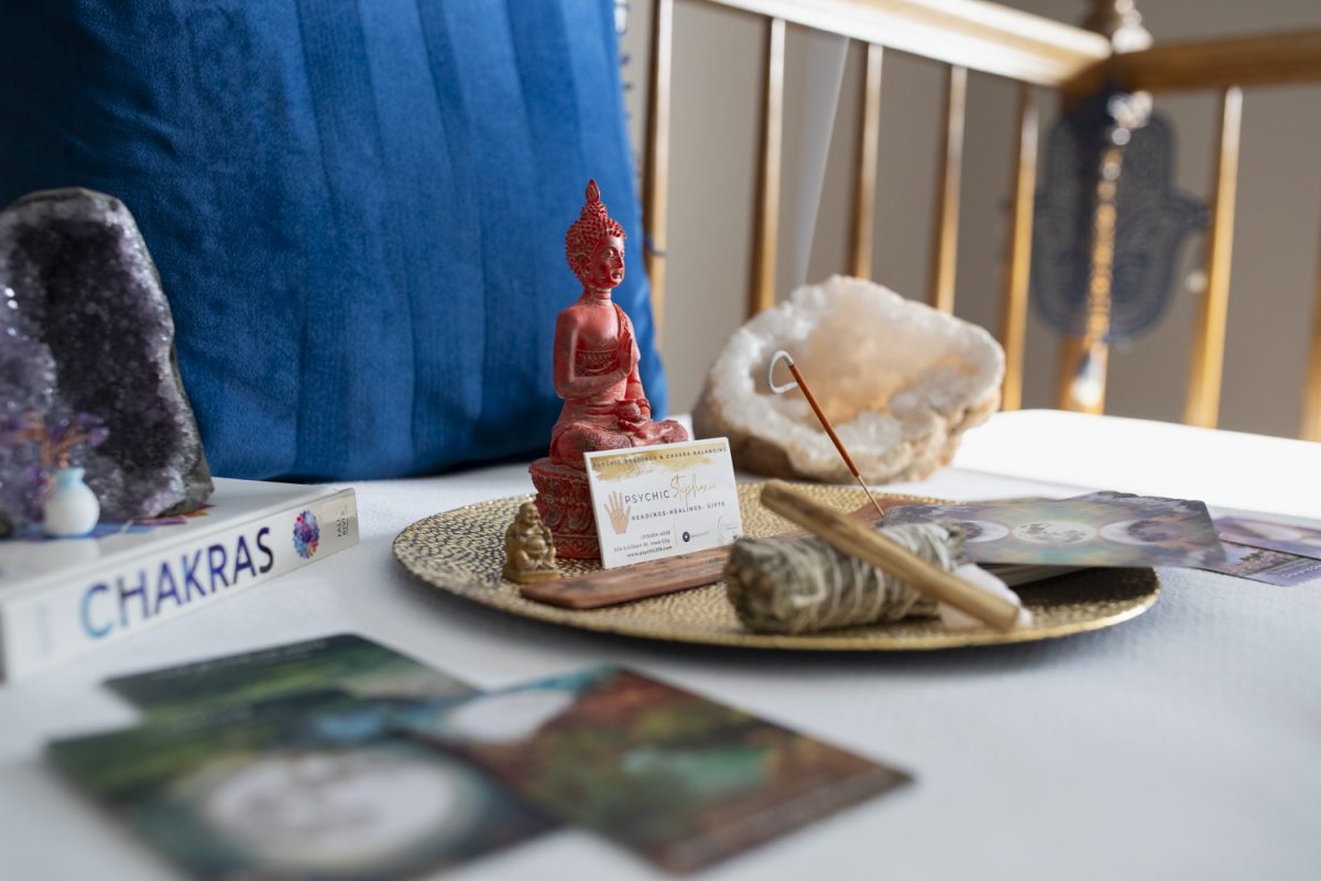 Stephanie Michelle poses for a picture at The Psychic Shop in Iowa City on Friday, Oct. 18, 2024. Michelle specializes in tarot readings and psychic readings, noting that October is a busy month for her business.