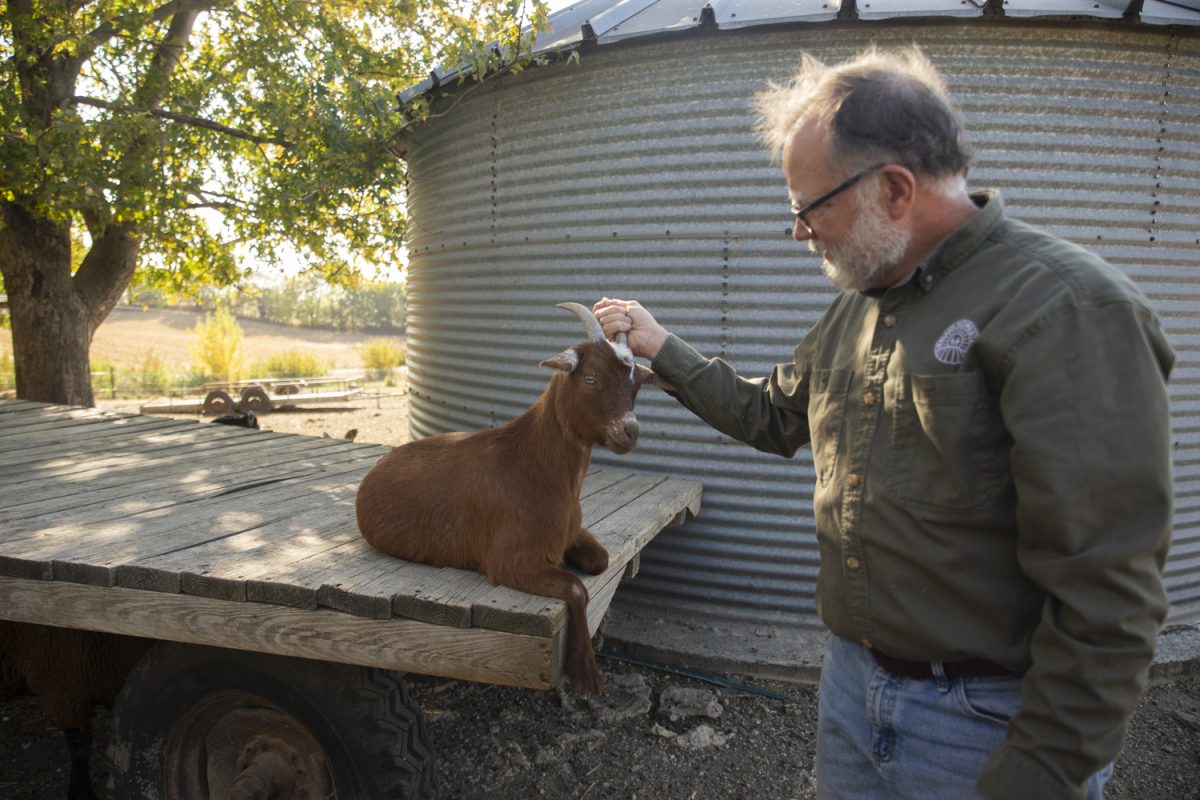 Bob Walker pets a goat during the first-ever bus tour at Walker Homestead in Johnson County on Oct. 20, 2024. The farmstead originally began as a farm-to-table service.