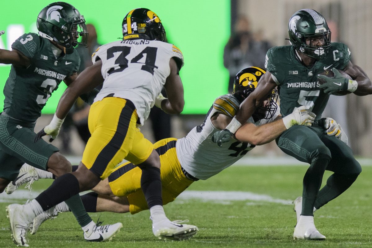 Iowa linebacker Karson Sharar tackles Michigan State Running Back Nate Carter during a game between the Iowa and Michigan State at Spartan Stadium in East Lansing, Mich., on Saturday, Oct. 19, 2024.