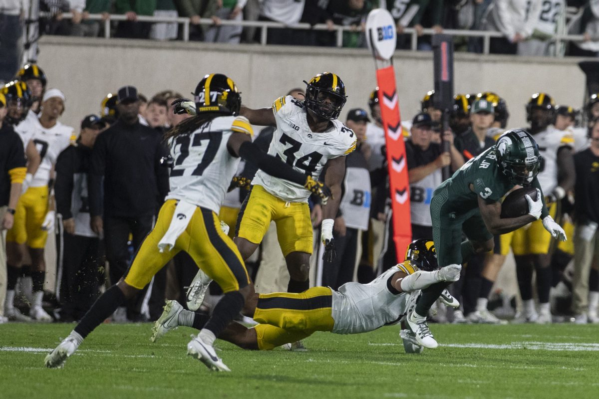 An Iowa player tackles Michigan State Wide Receiver Montorie Foster Jr. during a game between the Iowa and Michigan State at Spartan Stadium in East Lansing, Mich., on Saturday, Oct. 19, 2024. The Spartans defeated the Hawkeyes, 32-20.