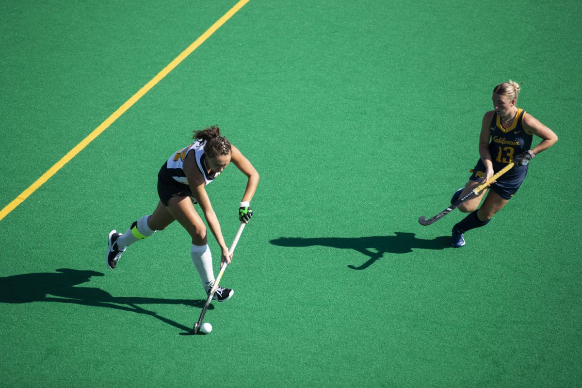 Iowa defender Harper Dunne runs the ball down the field during a field hockey game between No. 17 Iowa and No. 18 California at Grant Field in Iowa City on Sunday, Oct. 20, 2024. The Hawkeyes defeated the Golden Bears, 3-1.