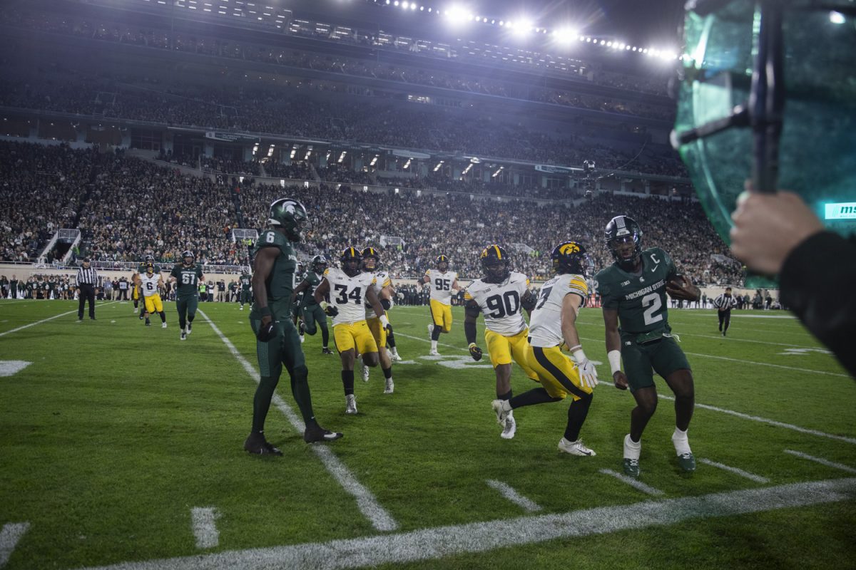 Michigan State Quarterback Aidan Chiles runs into the sidelines during a game between the Iowa and Michigan State at Spartan Stadium in East Lansing, Mich., on Saturday, Oct. 19, 2024. The Spartans defeated the Hawkeyes, 32-20.