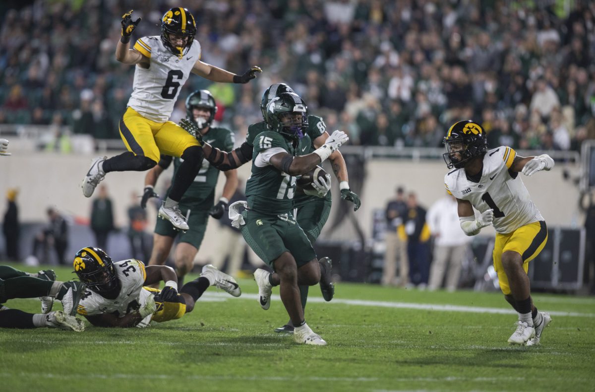 Michigan State Running Back Kay'ron Lynch-Adams runs from Iowa defense during a game between the Iowa and Michigan State at Spartan Stadium in East Lansing, Mich., on Saturday, Oct. 19, 2024. The Spartans defeated the Hawkeyes, 32-20.