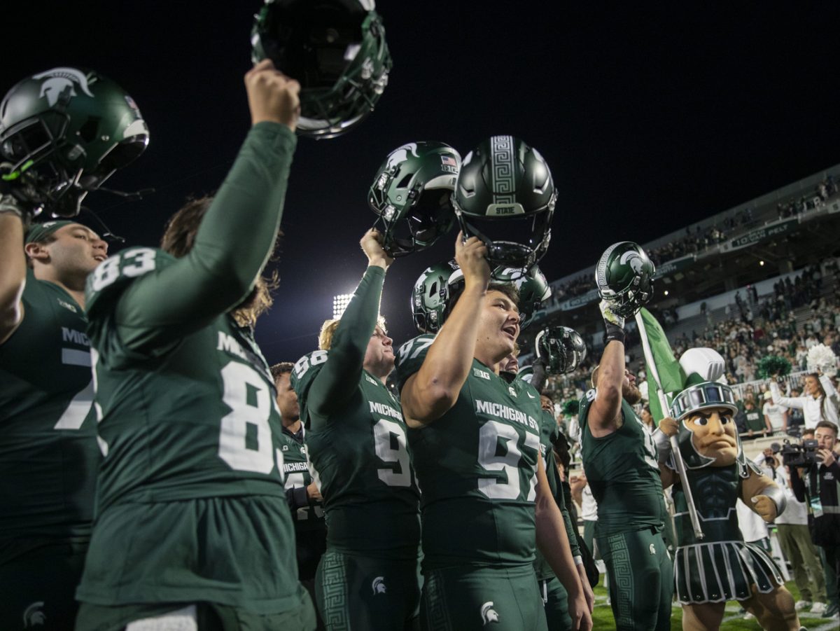 The Michigan State football team sings a song after winning a game between the Iowa and Michigan State at Spartan Stadium in East Lansing, Mich., on Saturday, Oct. 19, 2024. The Spartans defeated the Hawkeyes, 32-20.