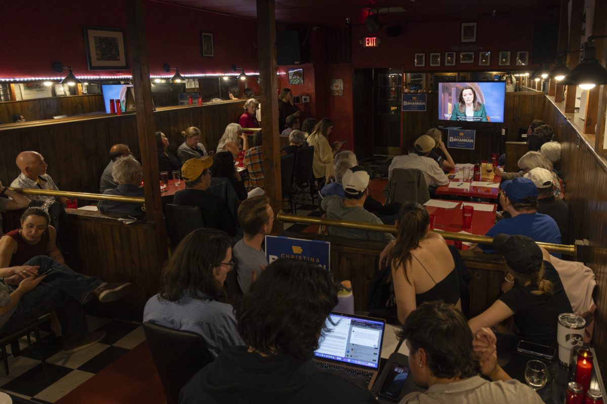 Local Democrats watch a debate between Christina Bohannan and U.S. Rep. Mariannette Miller-Meeks at Sanctuary Pub in Iowa City on Monday, Oct. 21, 2024. The watch party drew a packed crowd as eager voters listened to candidates for Iowa's 1st congressional District.