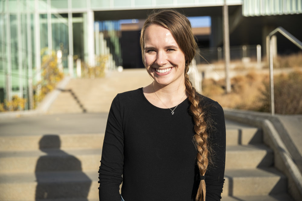 Aubrey McEnroe poses for a portrait outside of the Lindquist Center in Iowa City on Monday, Oct. 21, 2024. McEnroe is a doctoral candidate in counseling psychology specializing in telepsychology. 