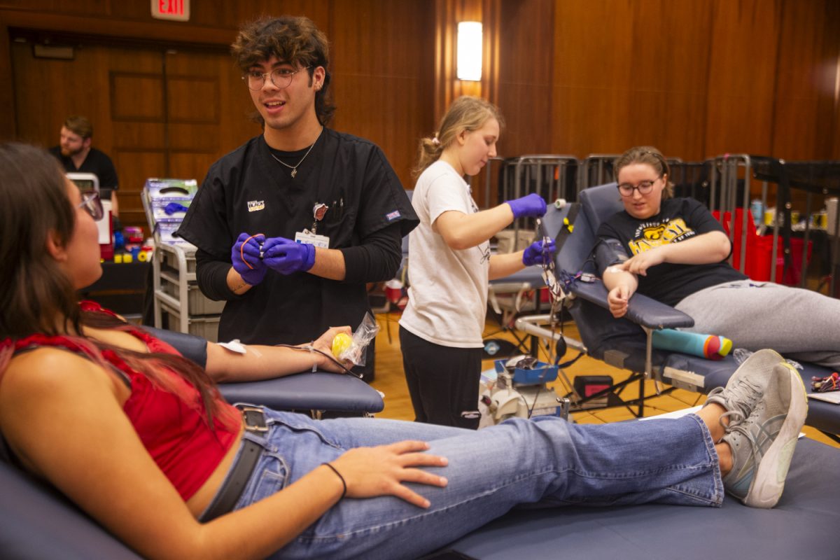 Nurses Joseph Hulsizer and Cassie Graves help students Ava Wheelock (left) and Caelan Cummins (right) donate blood during the 2024 Homecoming Blood Drive hosted by the DeGowin Blood Center in the Iowa Memorial Union on Tuesday, Oct. 22, 2024. The blood drive was set up by the University, which partnered with the regional blood donation center ImpactLife, based in Davenport, Iowa.